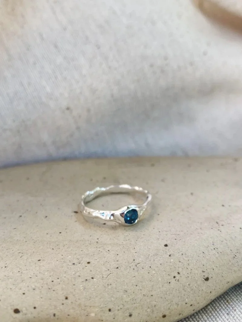 Wabi-sabi blue topaz ring with a natural gemstone, handcrafted in recycled silver or 14ct and 18ct gold for everyday wear.