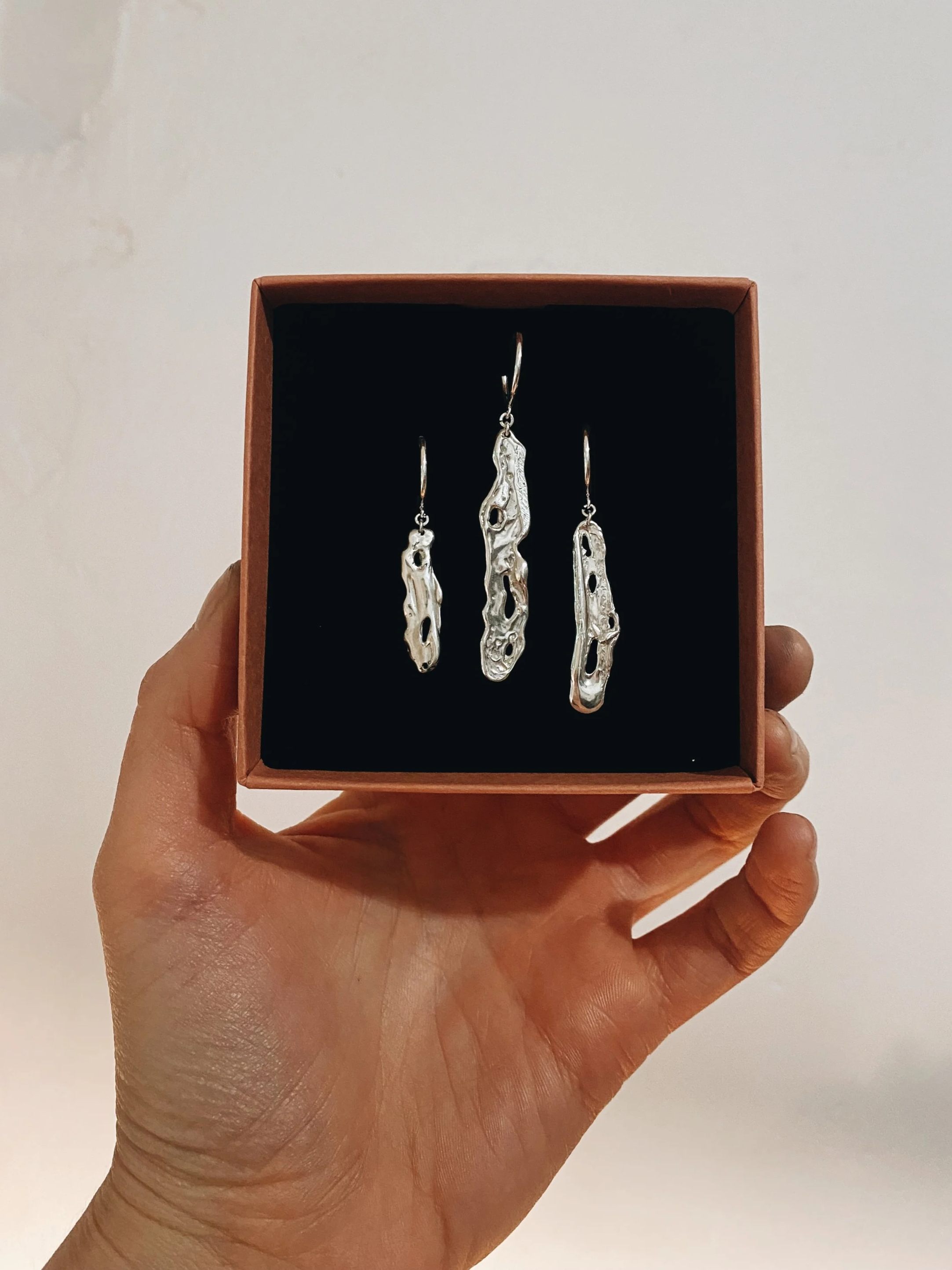 Three sizes of Juno earrings made in recycled silver.
