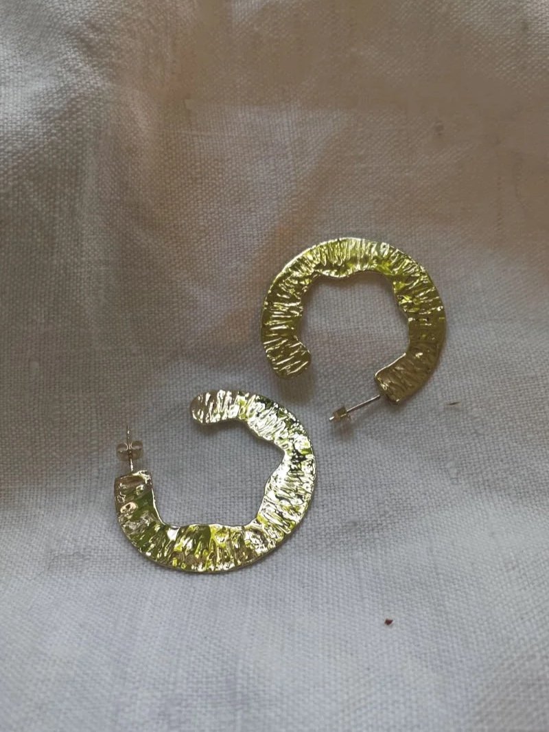 Handmade Cora earrings in recycled 14ct gold with a bold round shape, hand-hammered texture and feminine statement style.