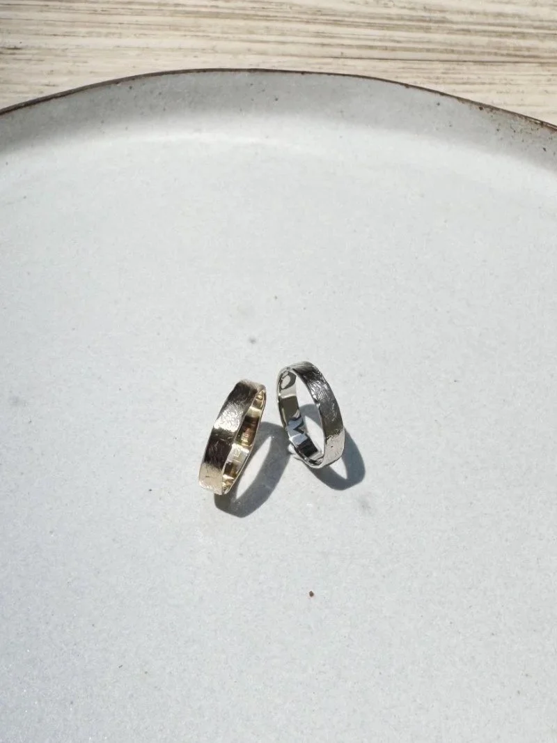 Handmade minimal wedding rings in gold with soft texture and timeless classic design for modern couples