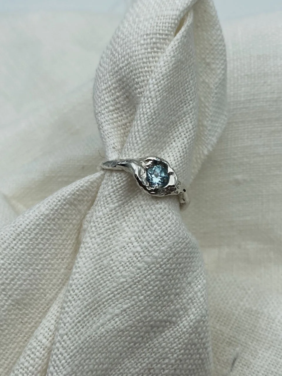 Wabi-sabi topaz ring with a beautiful light blue stone, handcrafted in recycled silver or gold for everyday wear or meaningful gifting.