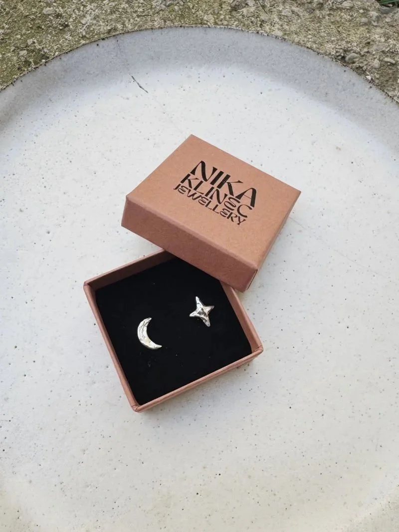 Small celestial stud earrings with moon and star pendants, handcrafted in recycled sterling silver or solid gold.