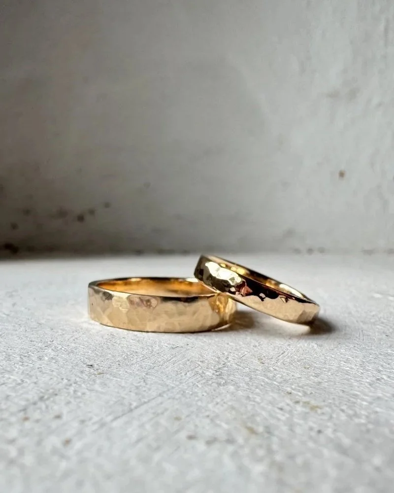 Hammered gold wedding ring bands made from recycled 14 carat gold.