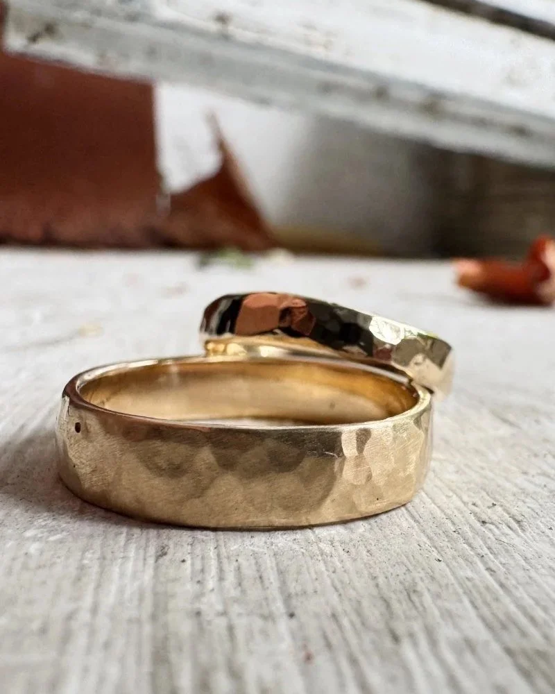 Handmade organic and modern textured wedding rings for him and her made from 14 carat recycled gold.