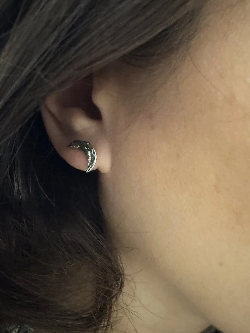 Recycled sterling silver moon and star stud earrings with delicate 1 cm charms and a timeless handmade finish.