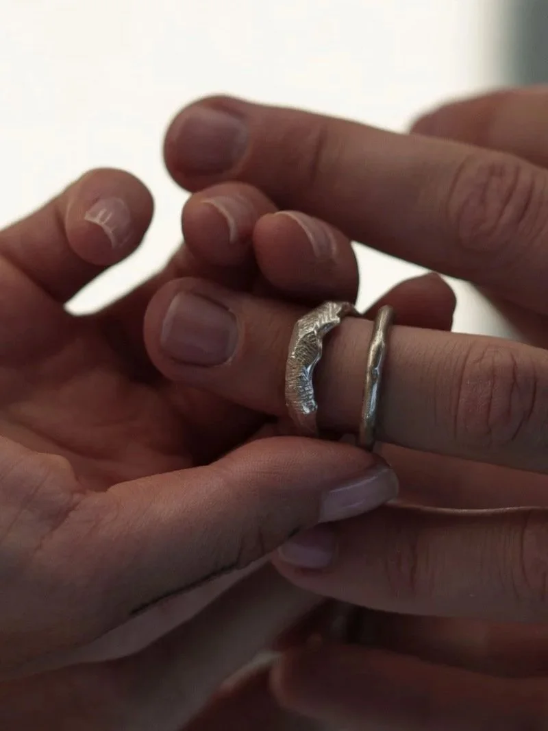 Unique silver statement ring for men featuring a wide band, uneven shape and edgy carved texture.