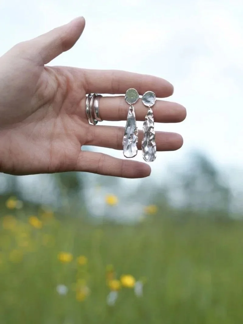 Organic silver earrings handcrafted from recycled sterling silver with a cratered lunar texture.