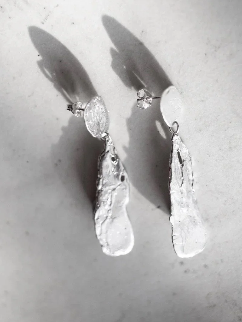 Bold handmade sterling silver earrings inspired by the moon, featuring a textured organic finish.