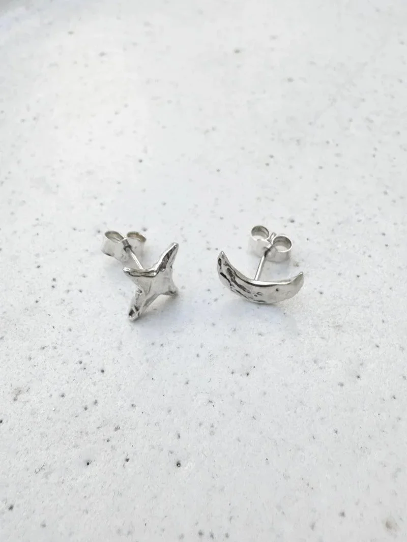Handmade moon and star stud earrings in recycled 925 sterling silver with dainty celestial charms and a modern minimal design.