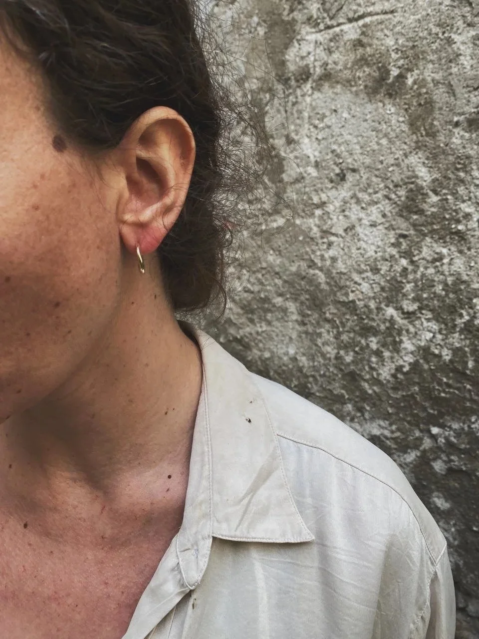Small handmade gold earrings in recycled 14ct or 18ct gold with organic shapes, raw texture and a modern wabi-sabi aesthetic.