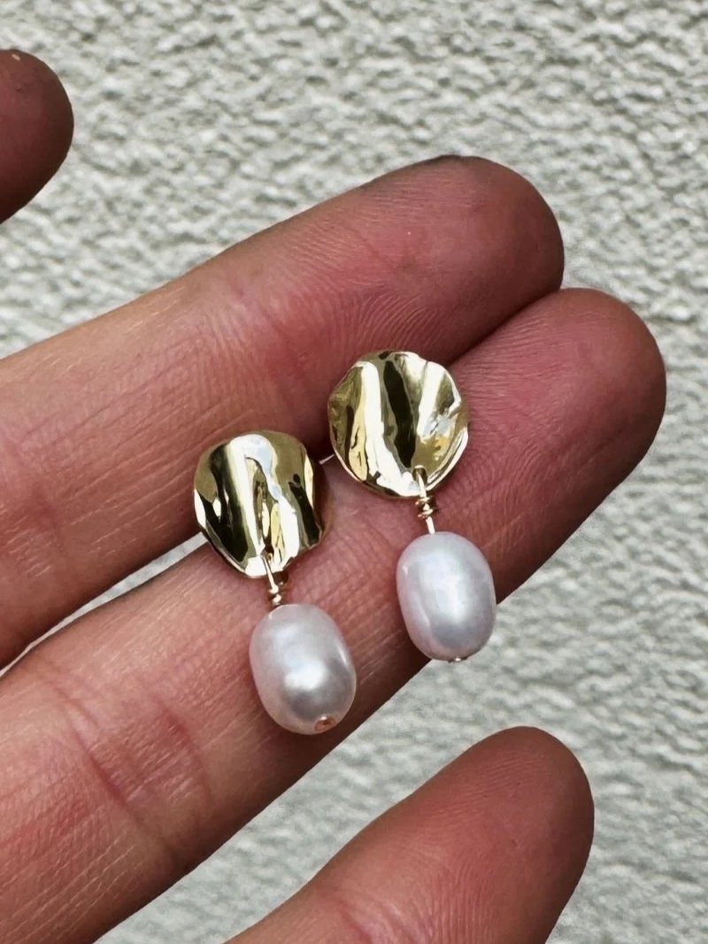 Handmade gold Deia earrings with asymmetrical design and real white pearls for modern women