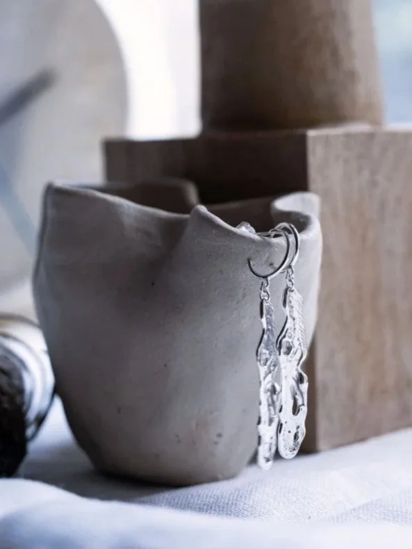 Statement silver earrings with molten texture, handmade in recycled sterling silver.