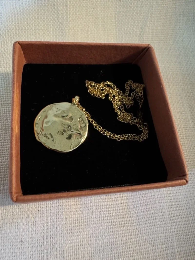 Celestial gold necklace with a hand-sculpted moon pendant, a unique handmade jewellery piece for everyday wear or gifting.