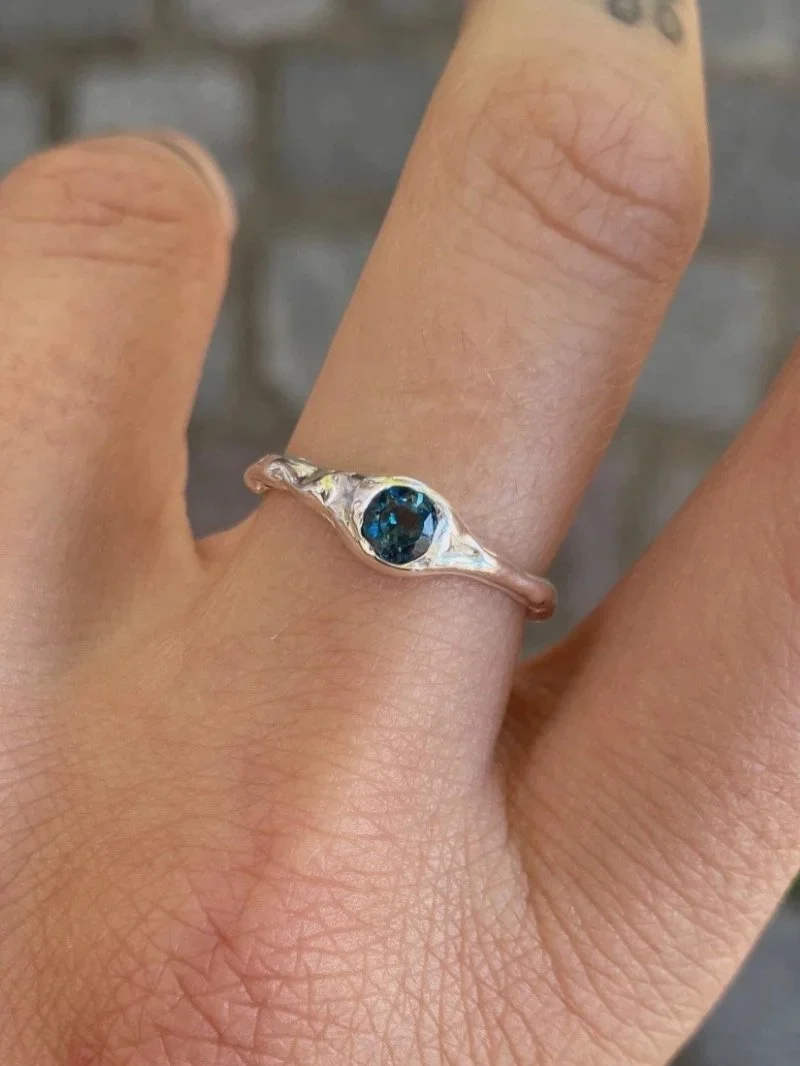 Natural blue topaz gemstone ring handcrafted in recycled sterling silver or gold, featuring an earthy, sculptural and modern look.