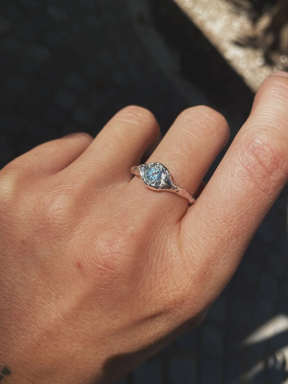 Modern wabi-sabi topaz ring with a beautiful light blue stone, handcrafted in recycled silver or gold.