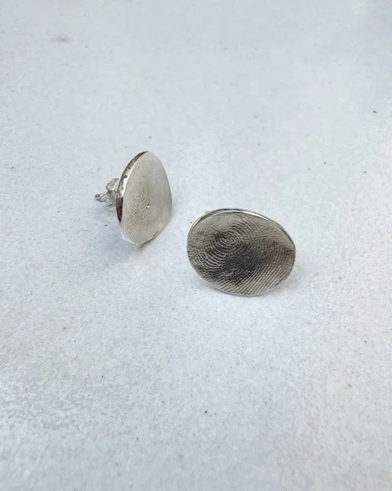 Fingerprint earrings in silver.