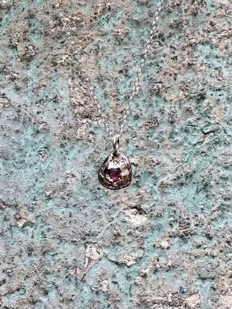 Artisan ruby pendant necklace with deep red gemstone, handcrafted in recycled silver or gold for lovers of modern organic jewellery.