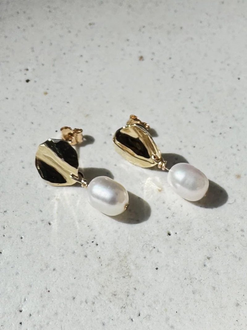 Handmade gold pearl earrings with organic golden discs and genuine white pearl pendants by Nika Klinec Jewellery