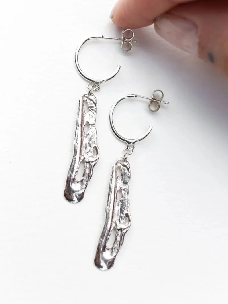 Liquid earrings are handcrafted from recycled sterling silver, featuring an organic molten texture and a luminous polished finish.