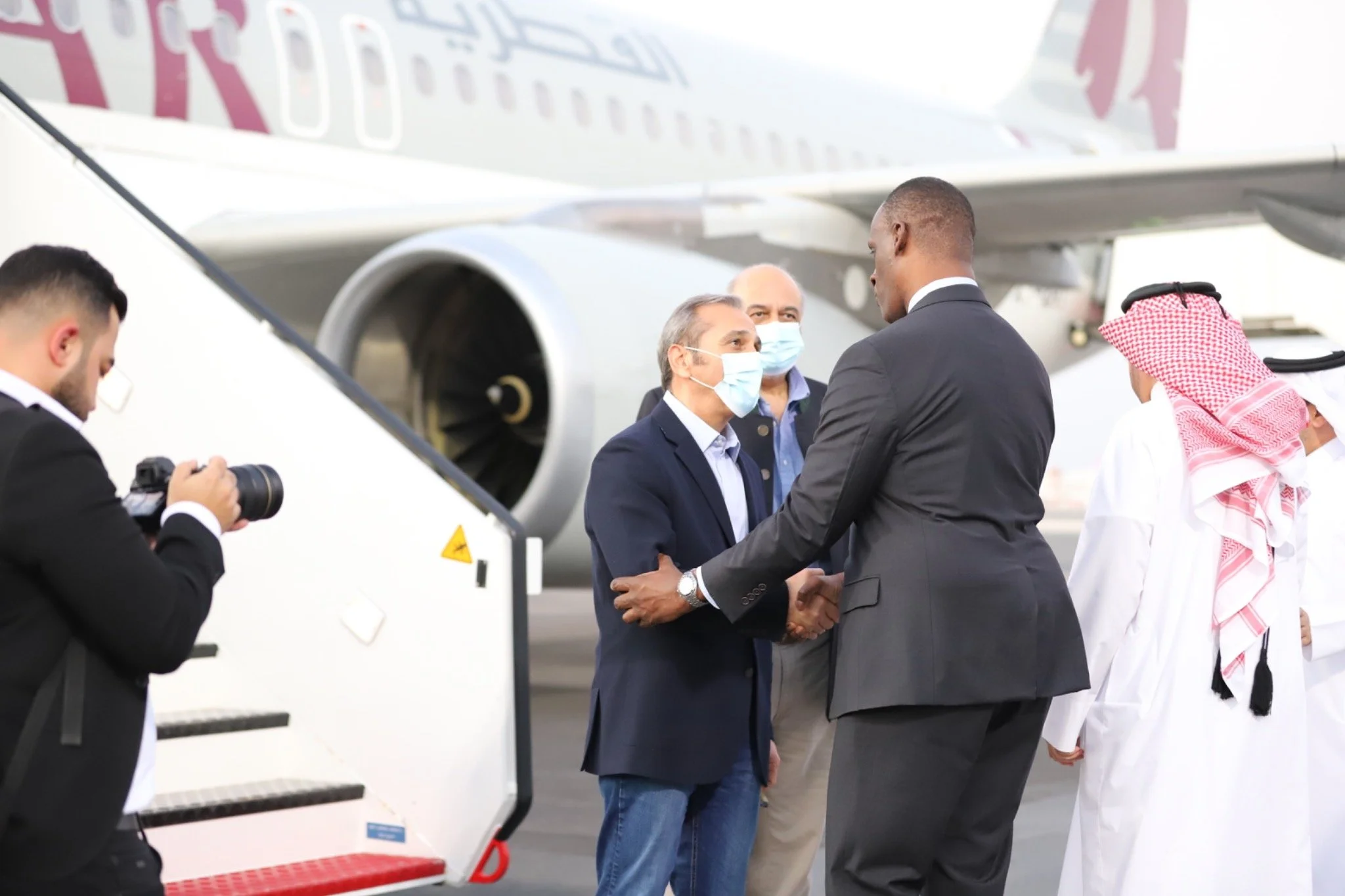 Emad Shargi, former American hostage in Iran, shaking hands during his arrival at Doha following his release.