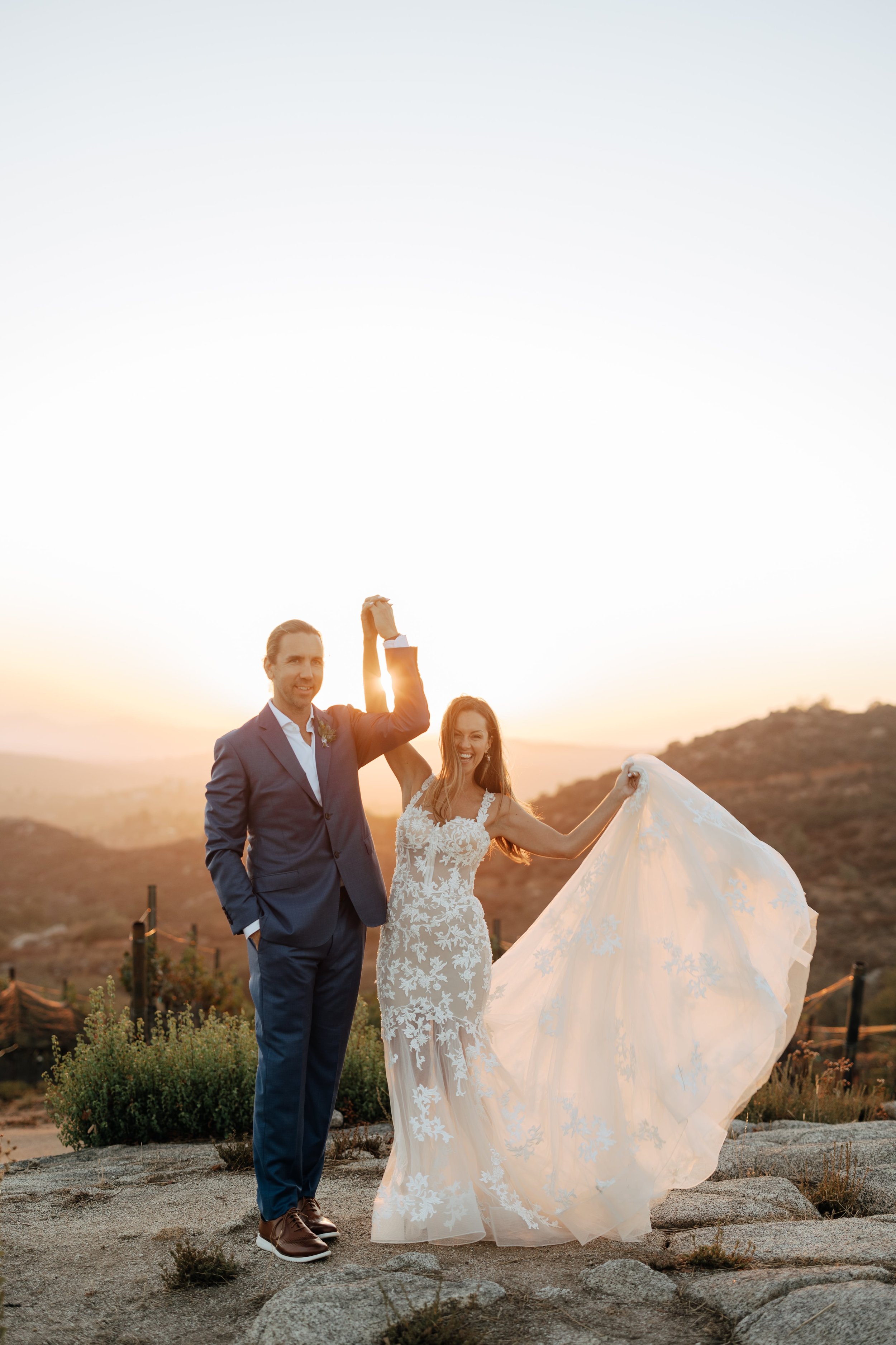 A couple holding hands celebrating their marriage at Milagro in Ramona, California.