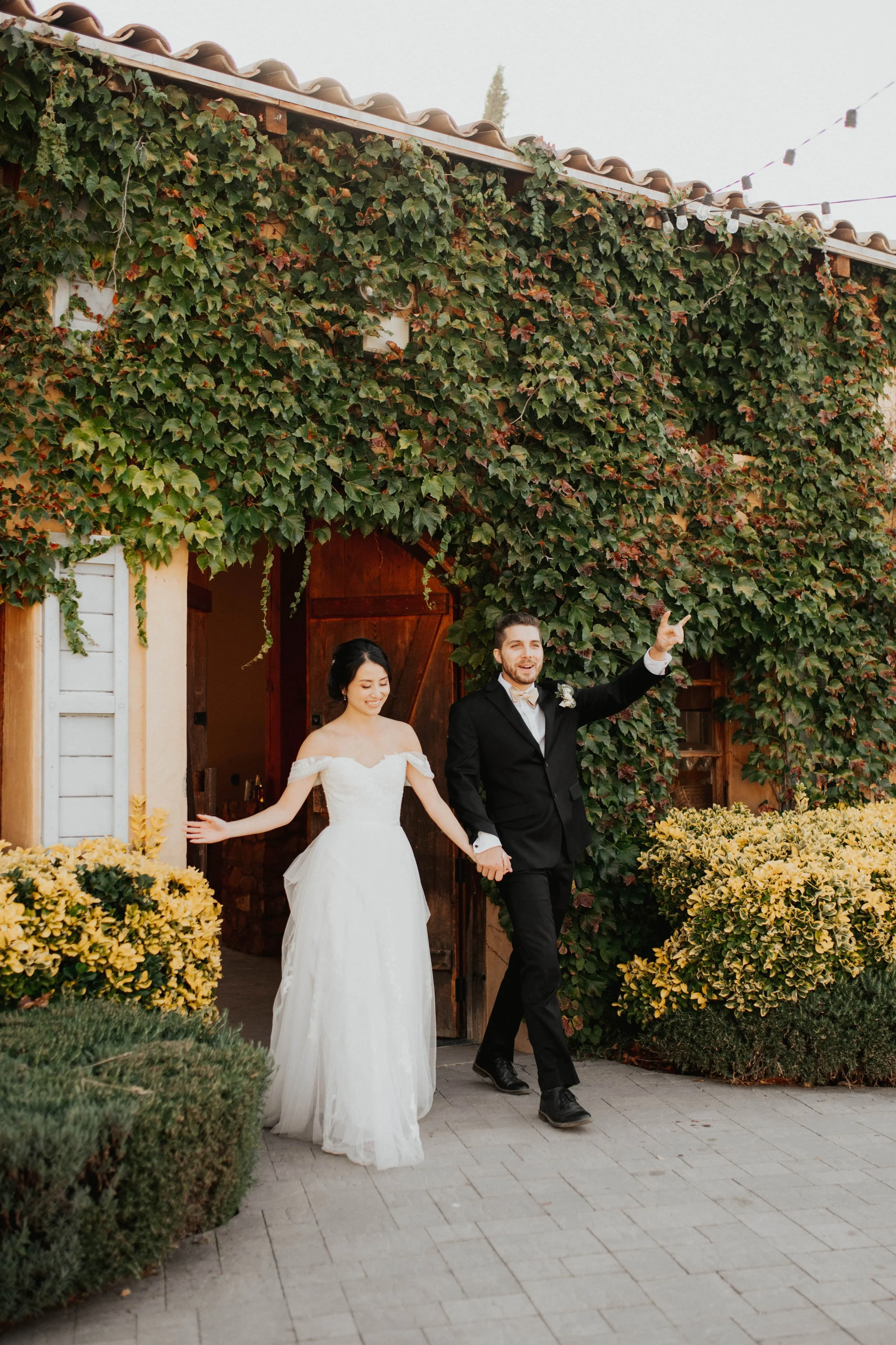 A couple walking out of the Crush House after getting married at Milagro Milagro in Ramona, California.