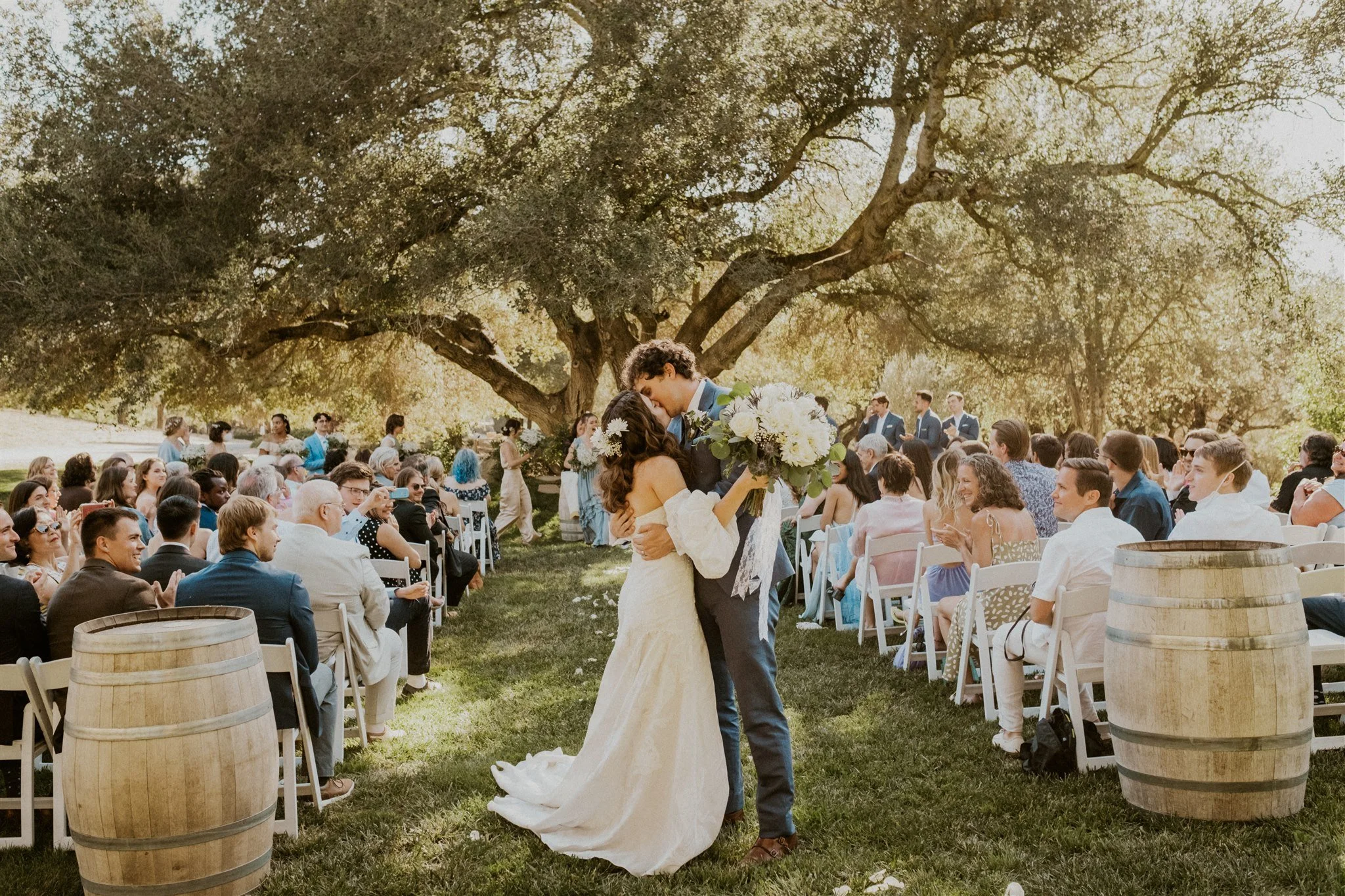 A couple getting married on the stunning outdoor Ceremony Lawn at Milagro in Ramona, California. 