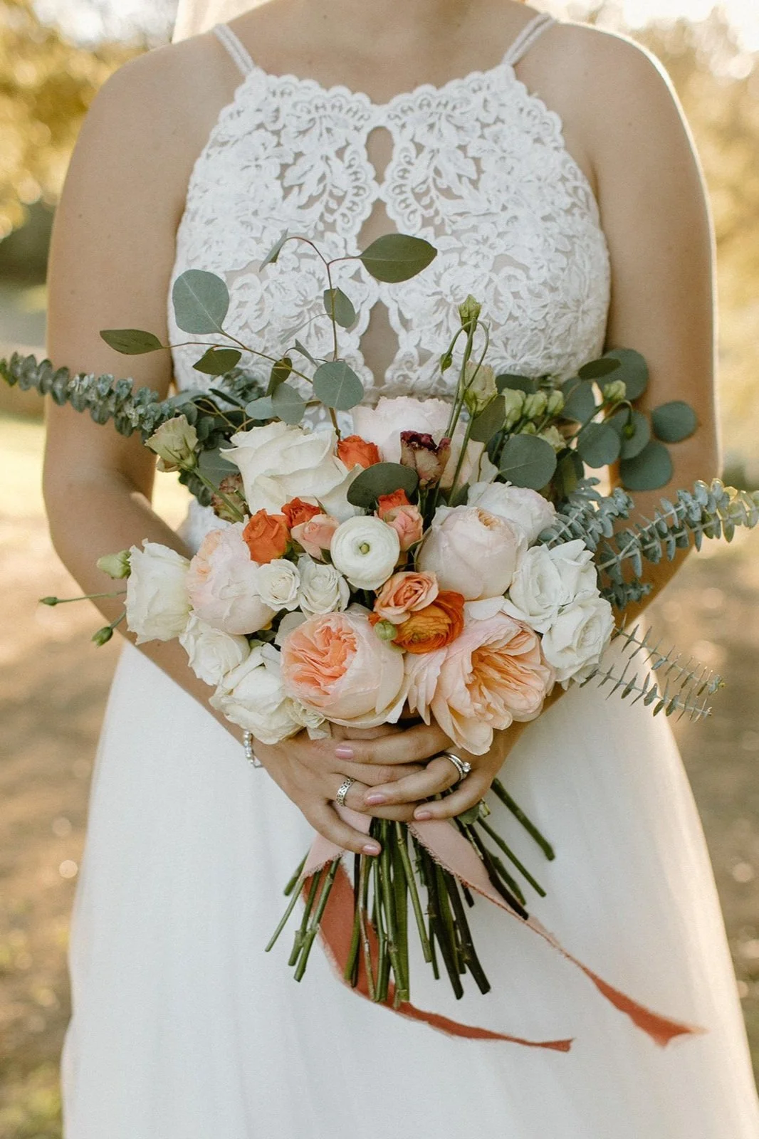 A bride holding a flower bouquet on her wedding day at Milagro in Ramona, California.