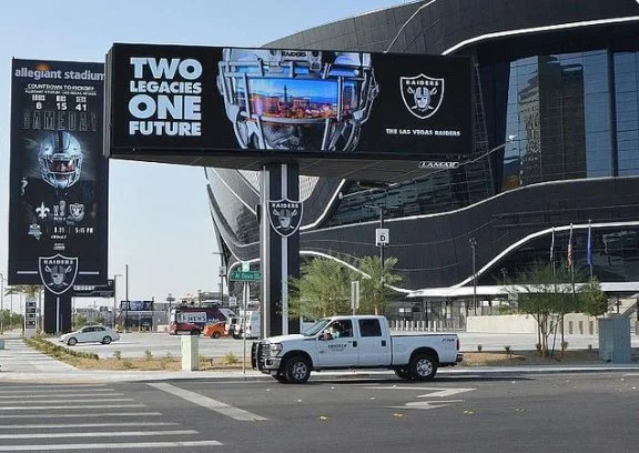 Large digital billboard advertising the Raiders football team Allegiant Stadium. large digital billboard, wall mount billboard, billboard, billboard upgrade, LED billboard, wood pole billboard, OOH, custom billboard, digital billboard