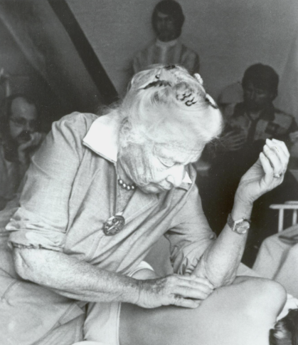 image of an old black and white picture ida Rolf working on a client