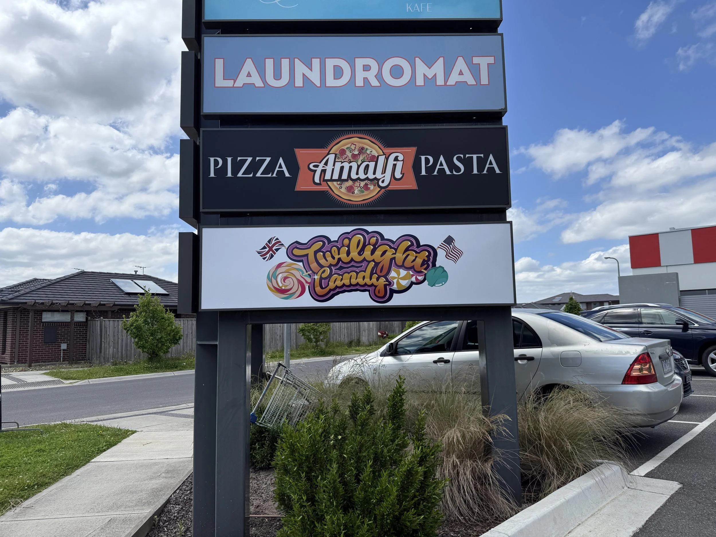 Exterior of a building with a large sign reading 'ELITE. INDOOR SPORTZ', with silhouetted images of various sports including baseball, wheelchair basketball, soccer, volleyball, and tennis painted on the wall.