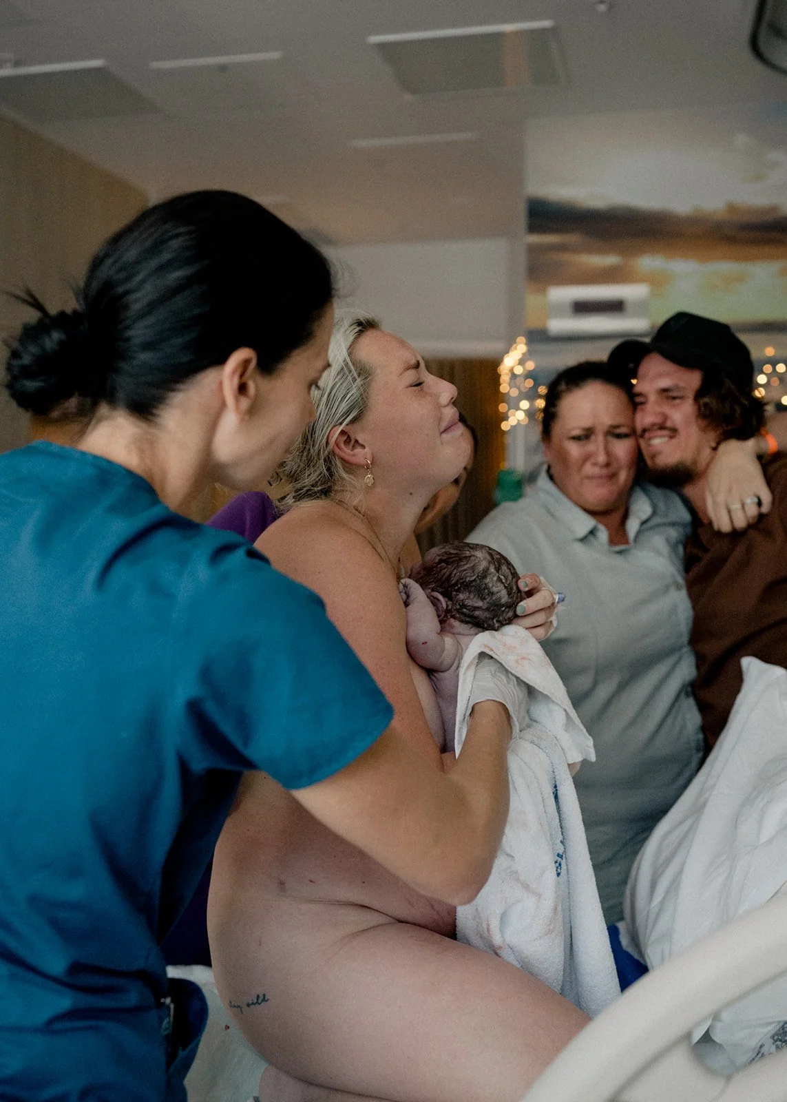 Newborn baby being held by mother immediately after birth in a Sunshine Coast hospital
