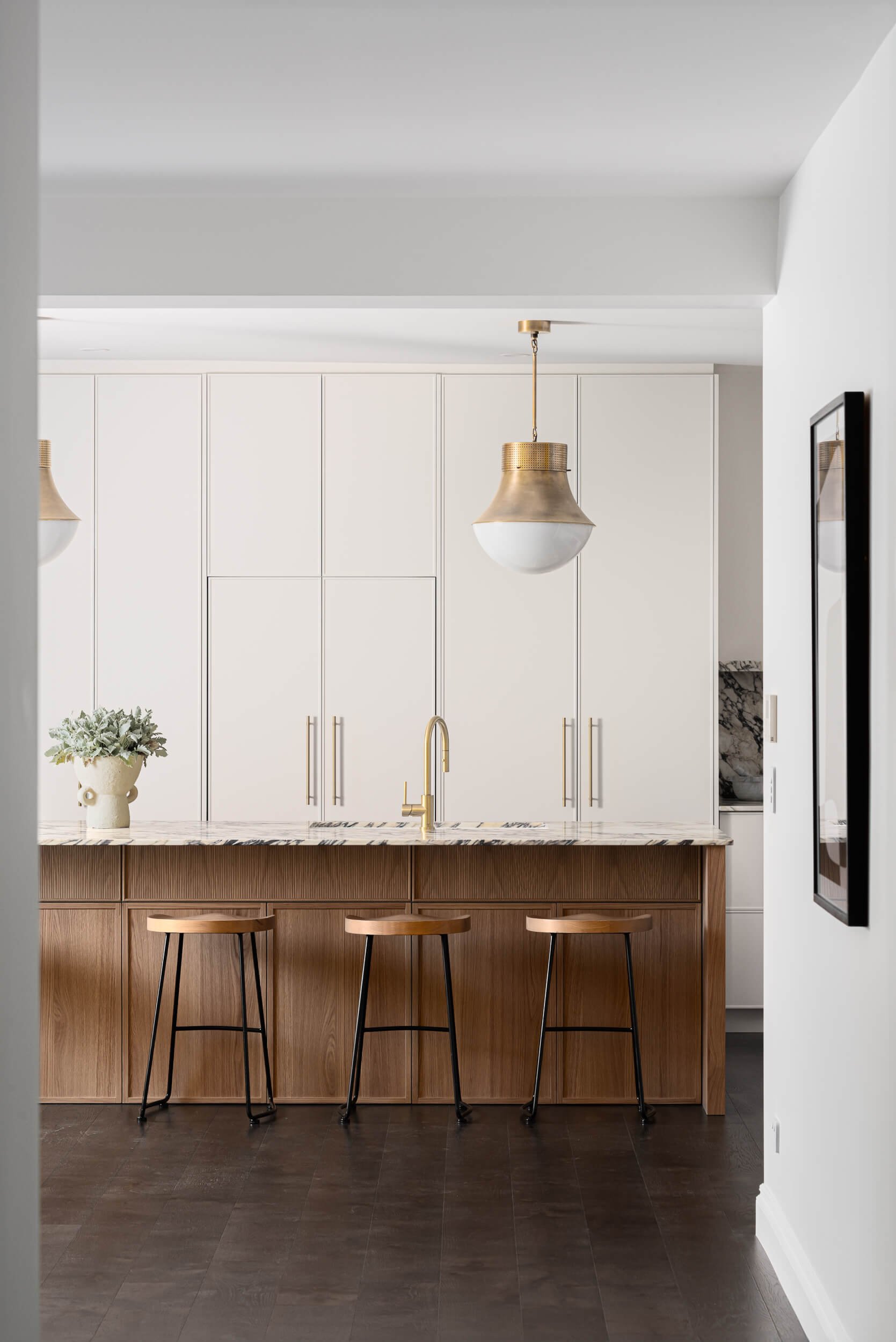 Premium architectural photography and film documenting true materiality, spatial flow, and high-end joinery—featuring a fluted timber island and marble benchtops—for a custom kitchen build in Regional NSW.