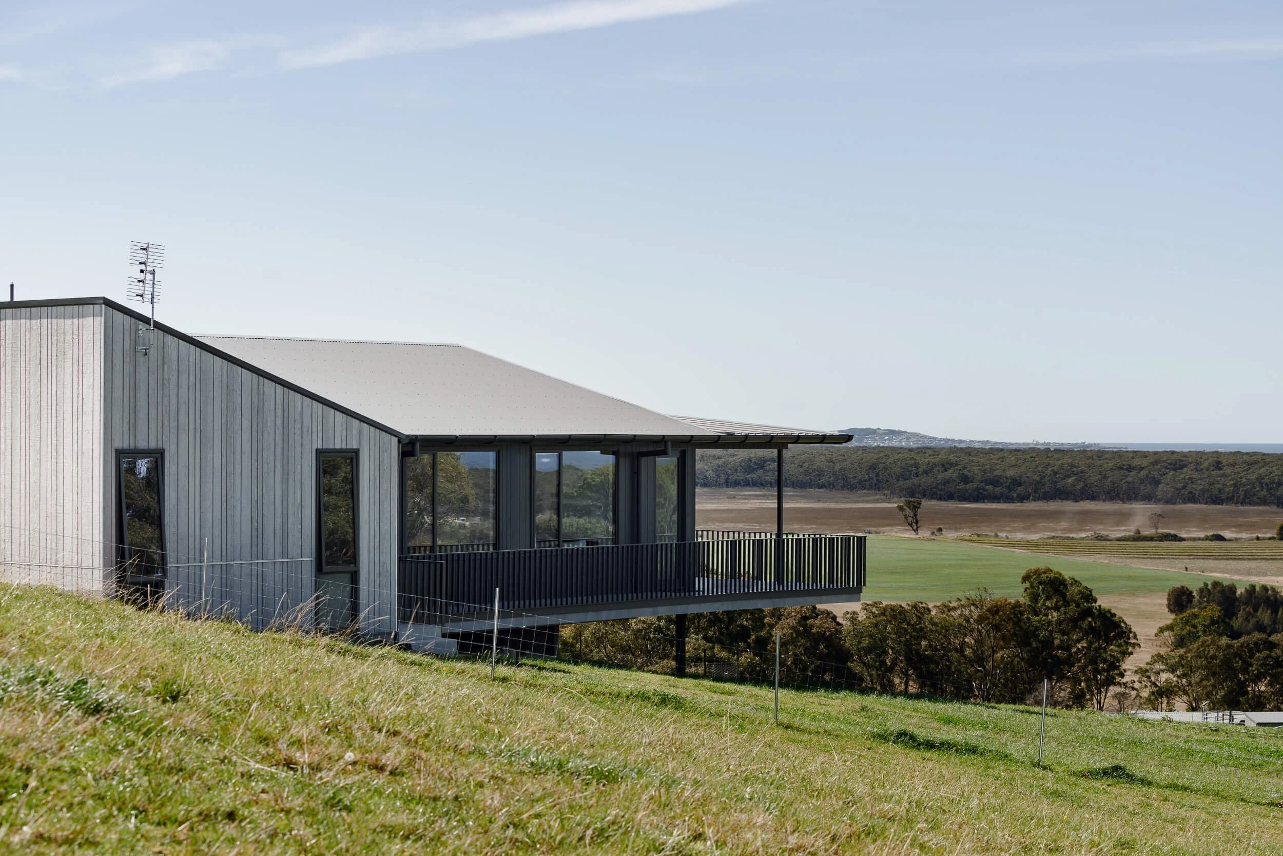 260-degree coastal views at Seven Mile. Premium architectural photography and film documenting an off-grid custom build by QBC Constructions in Regional NSW.