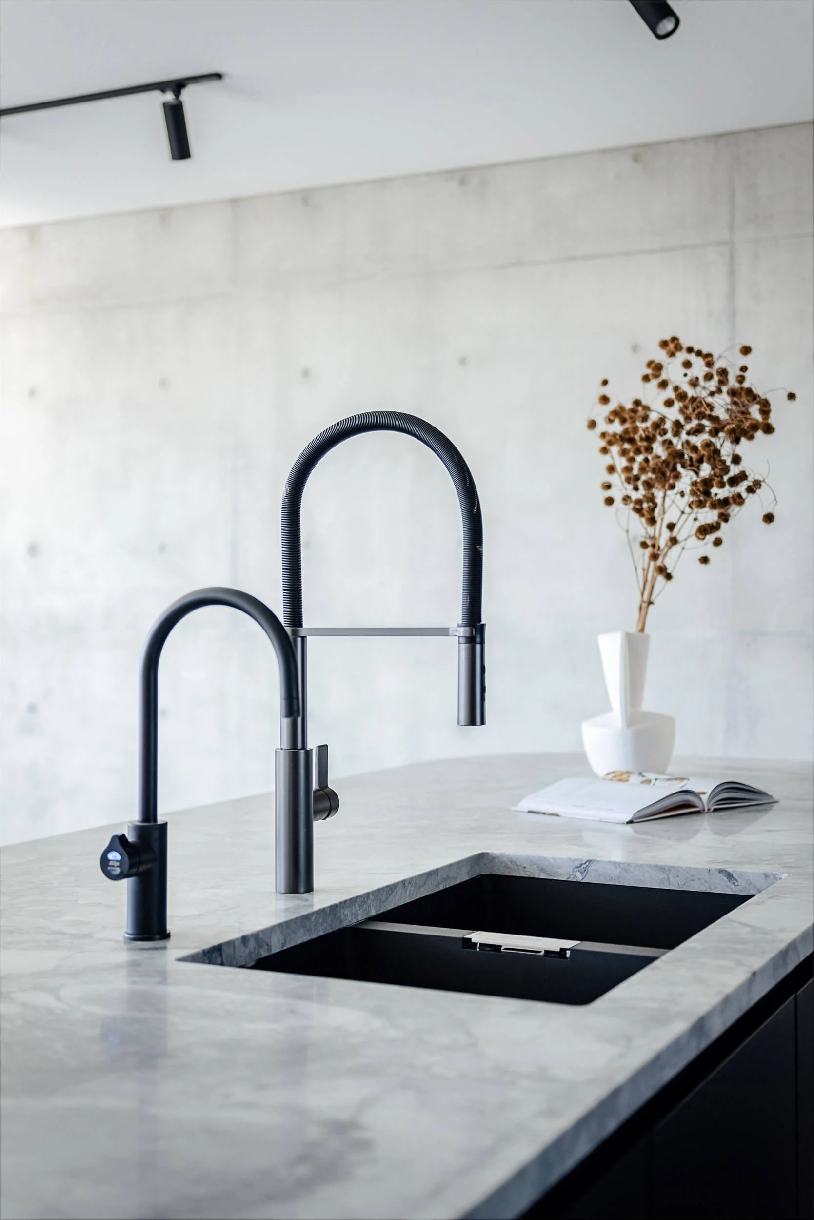 Premium architectural photography and film documenting true materiality and craftsmanship—highlighting matte black sink tapware, marble benchtops, and off-form concrete textures—for Master Builders and designers in Regional NSW.