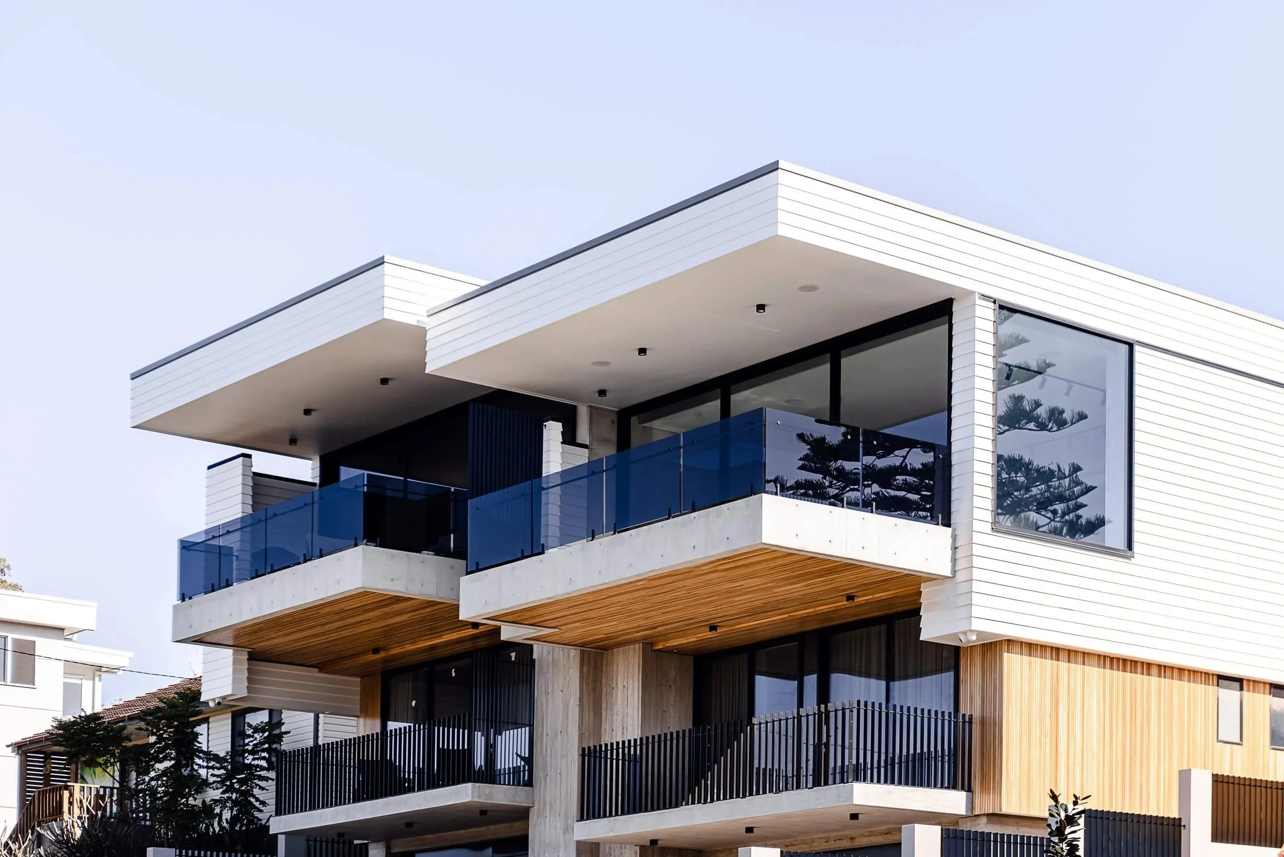 Premium architectural photography and film documenting true materiality and craftsmanship—highlighting a dual-wing structural design, cantilevered concrete, and expansive custom glazing—for Master Builders and designers in Regional NSW.