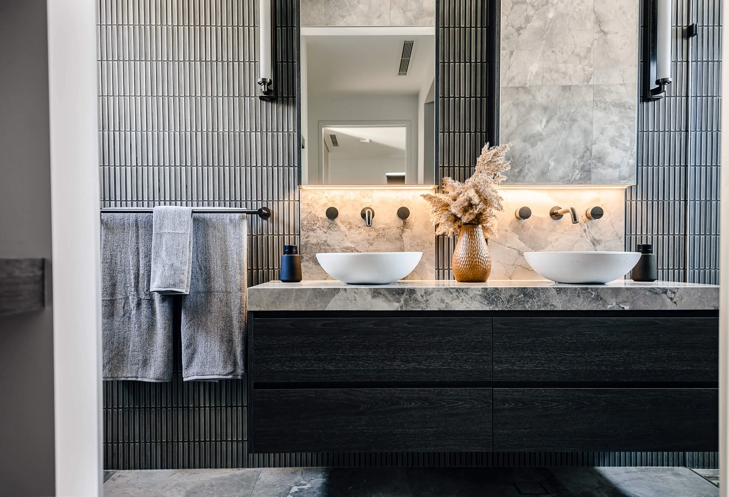 Premium architectural photography and film documenting true materiality and craftsmanship—highlighting floating timber joinery, marble tops, and structured bathroom design—for Master Builders and designers in Regional NSW.