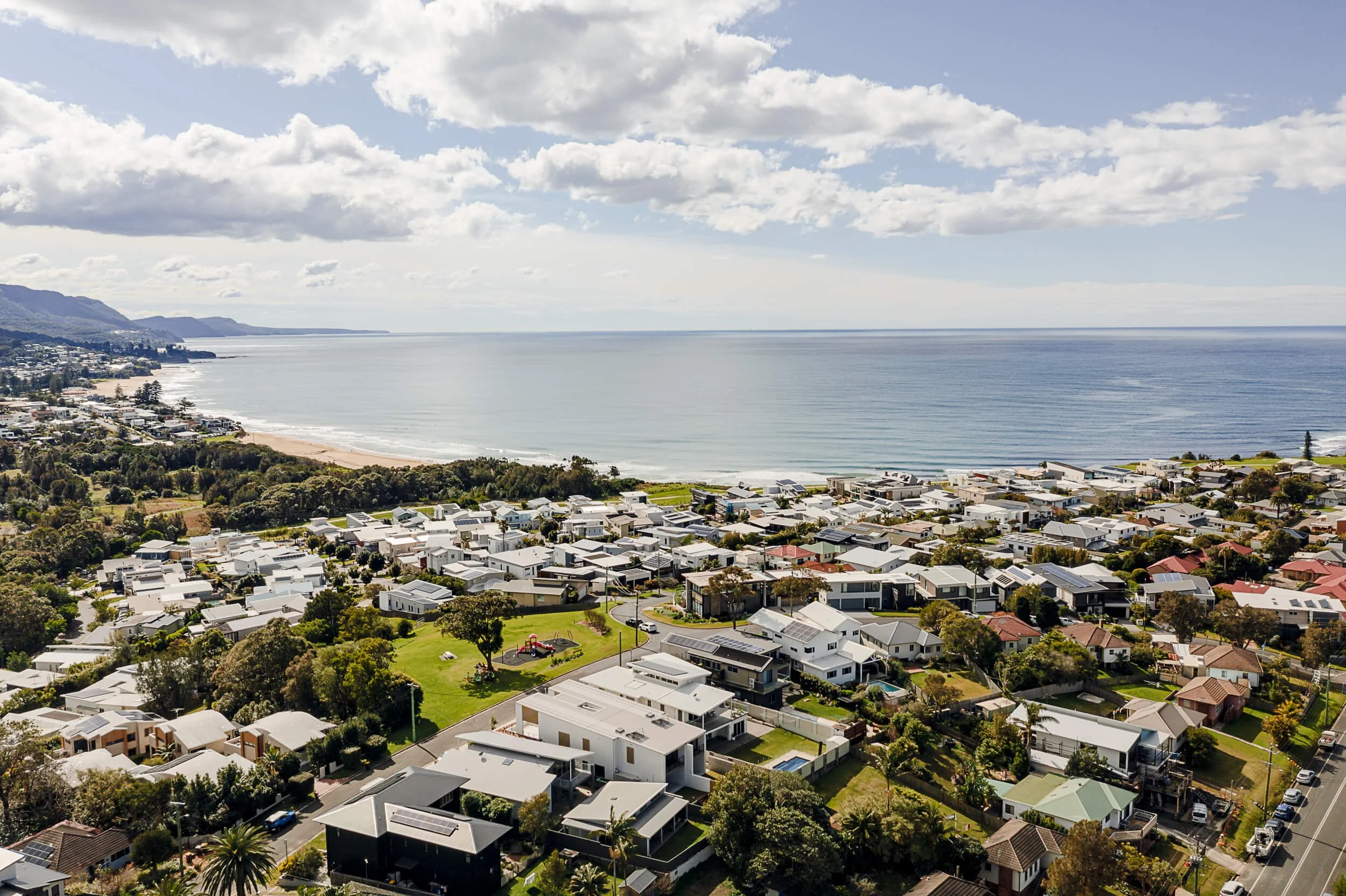 Panoramic aerial view of Bulli coastline and coastal reserve showcasing the regional NSW environmental setting of O'Brien Duplex by Kibbin Design and SLD Projects