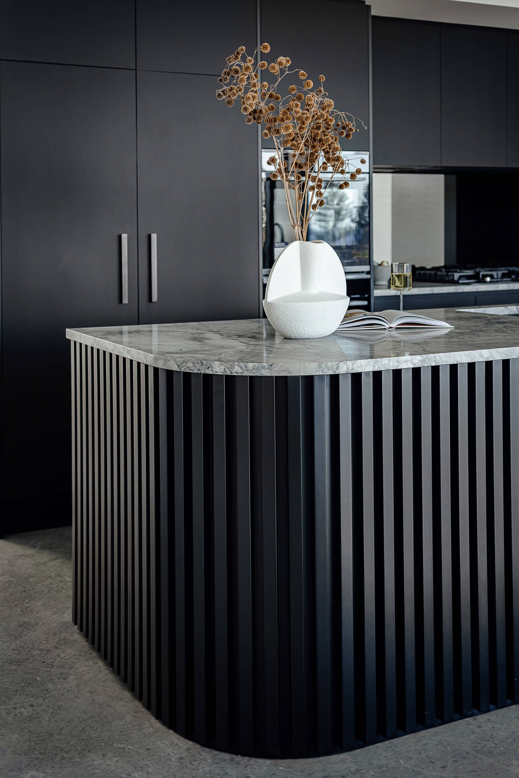 Premium architectural photography and film documenting true materiality and craftsmanship—highlighting custom ribbed timber island profiles and polished concrete floors—for Master Builders and designers in Regional NSW