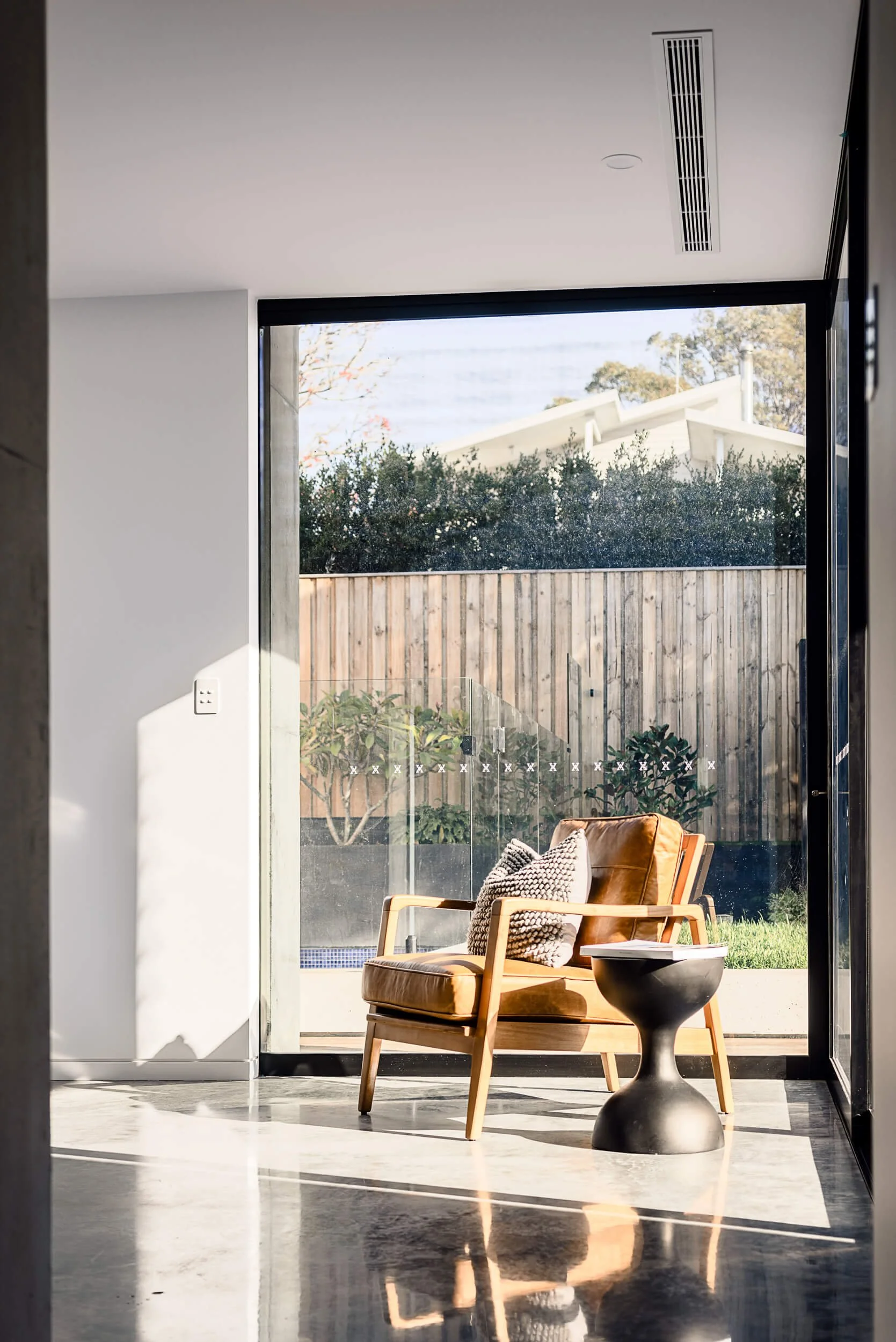 Premium architectural photography and film documenting true materiality and craftsmanship—highlighting seamless indoor/outdoor transitions and heavy structural framing—for Master Builders and designers in Regional NSW.