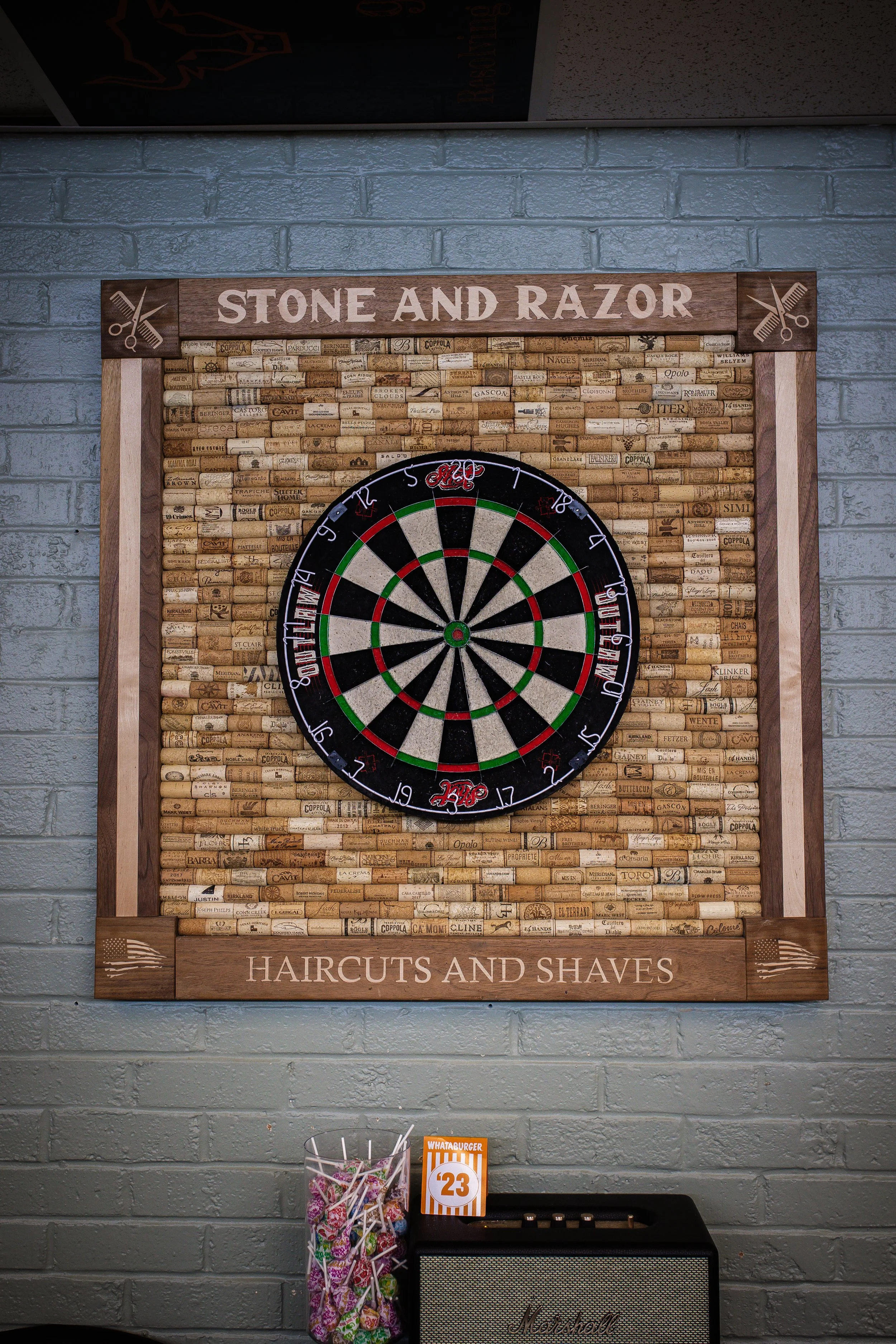 The dartboard at Stone and Razor Barbershop in Burleson, Texas
