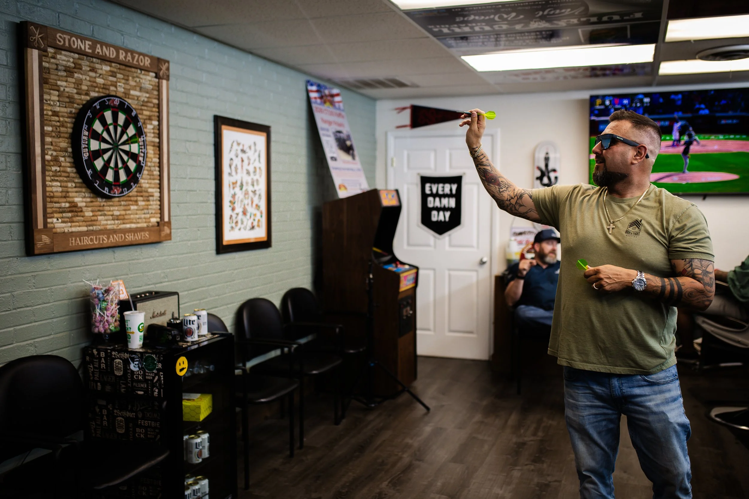 Customer throwing darts at Stone and Razor Barbershop in Burleson, Texas