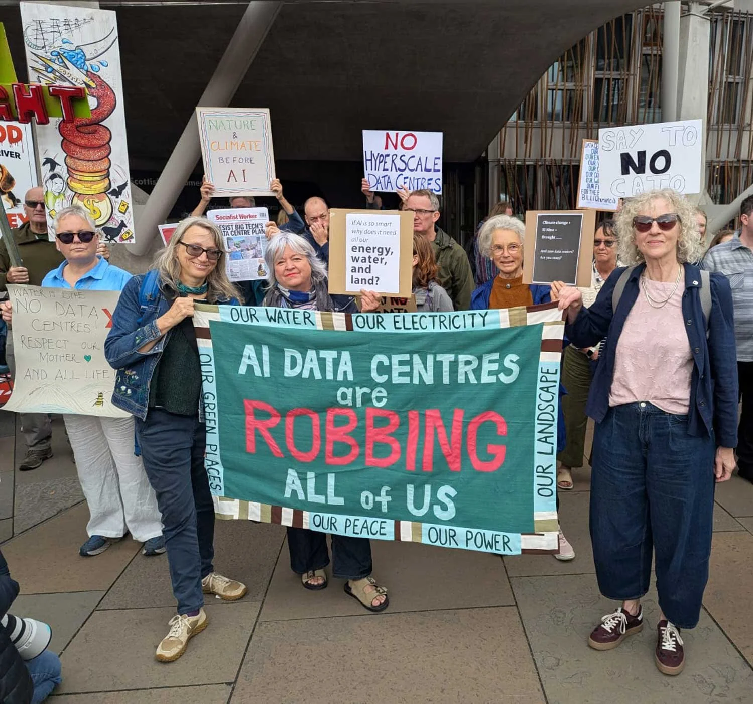 Protesters against AI data centres with handmade banner