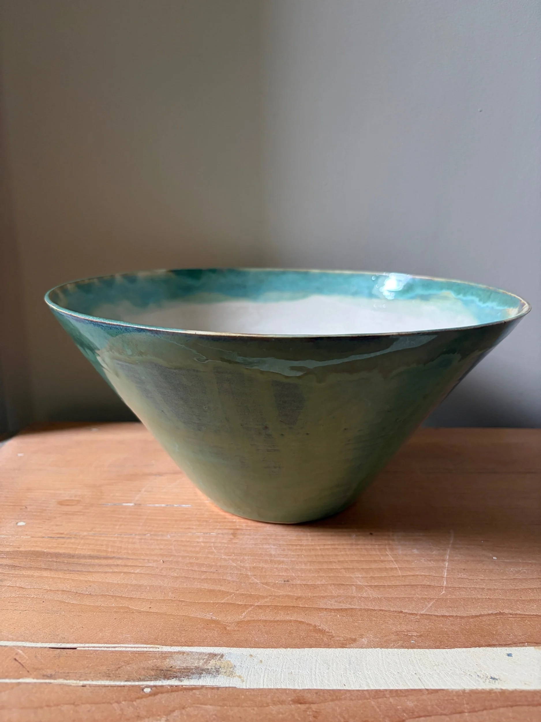 Large V shaped bowl in pistachio glaze with white satin interior glaze