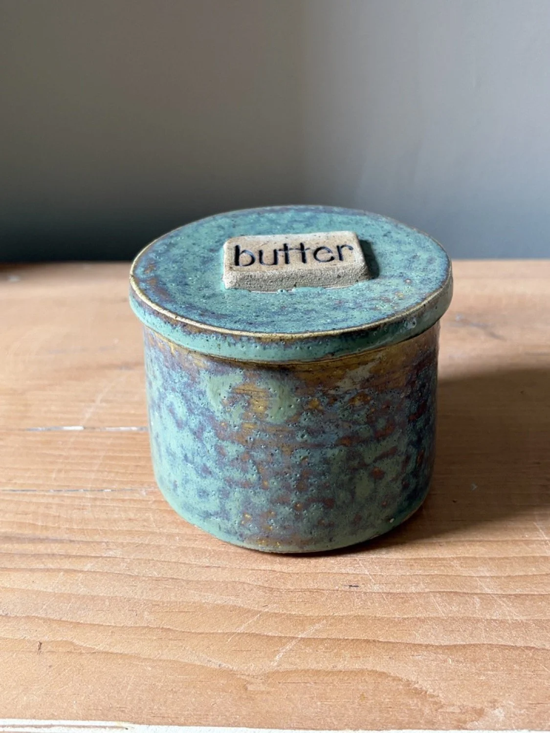 Handmade stoneware pottery french butter press in a pistashio colour glaze