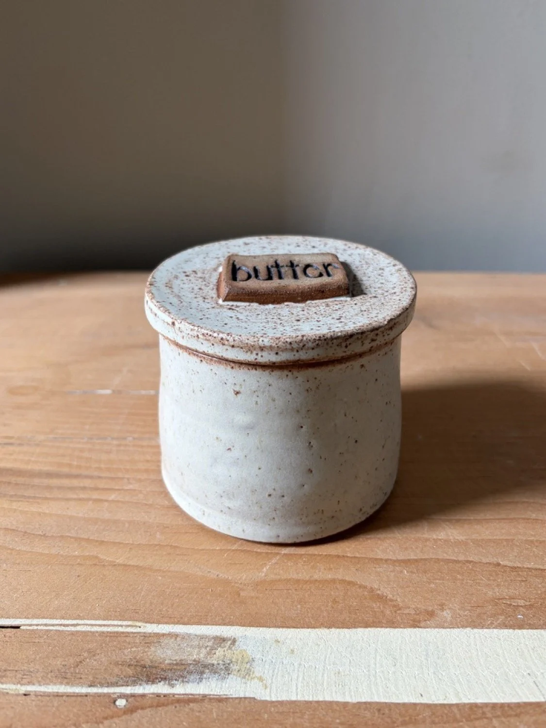 Handcrafted stoneware ceramic french butter press in a vanilla glaze
