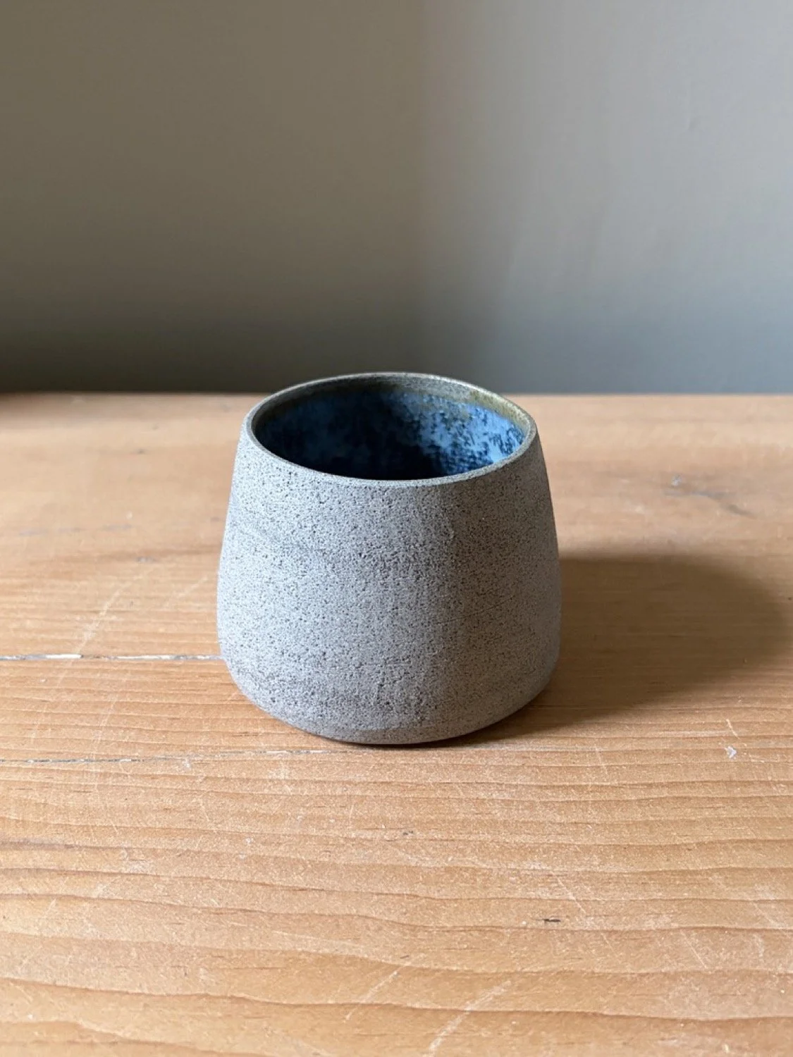 Handcrafted pottery with a handleless cup in glacier glaze