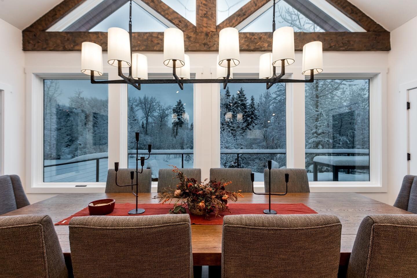 Enjoying the holiday season with a beautiful view of the snow outside from this aged oak dining table. #holidayseason #snowyview #diningroom #cozyvibes