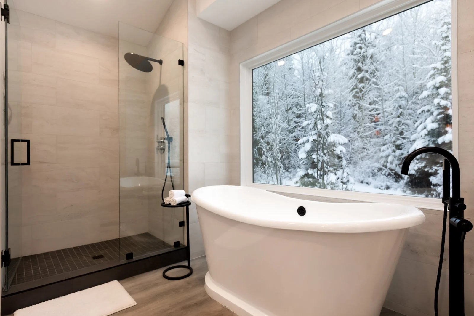 Primary bathroom overlooking the winter forest at Back Forty Lodge