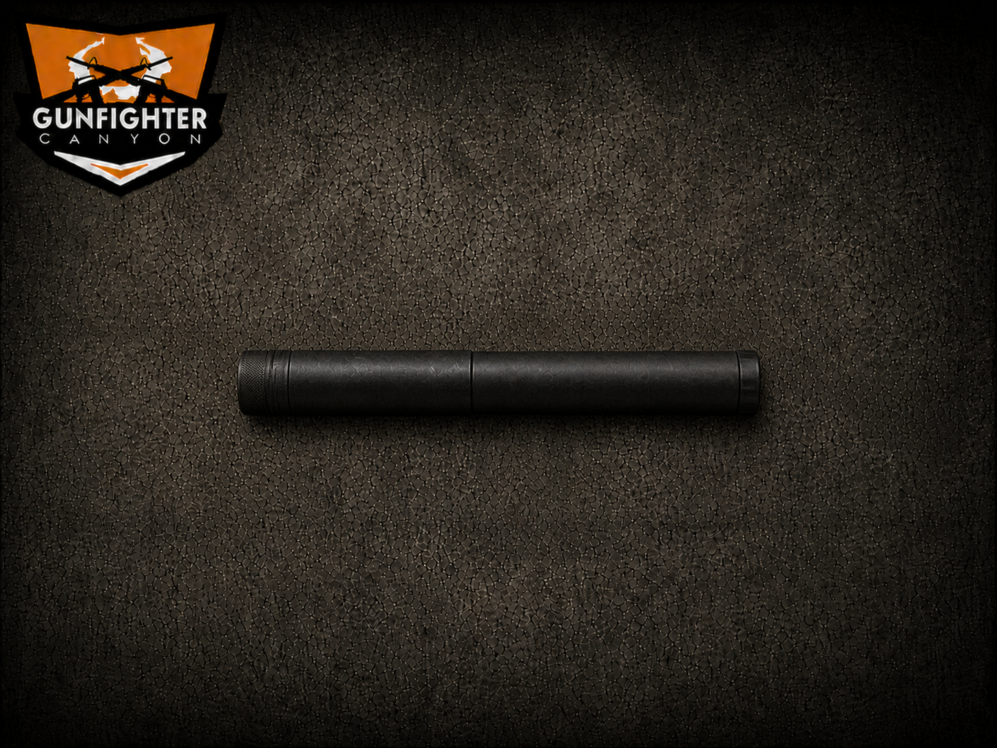 Black cylindrical object on a textured dark surface, with a logo in the top left corner reading 'Gunfigher Canyon' with crossed guns in an orange shield.